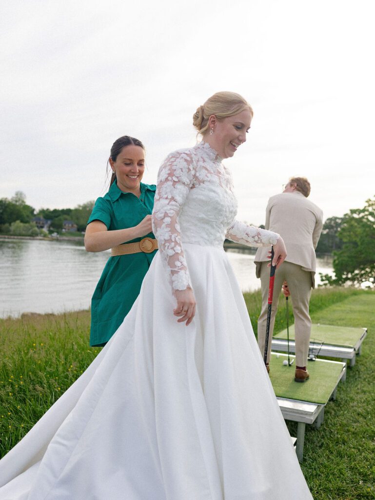 Charleston wedding planner bustling bride's dress at her Annapolis tented wedding