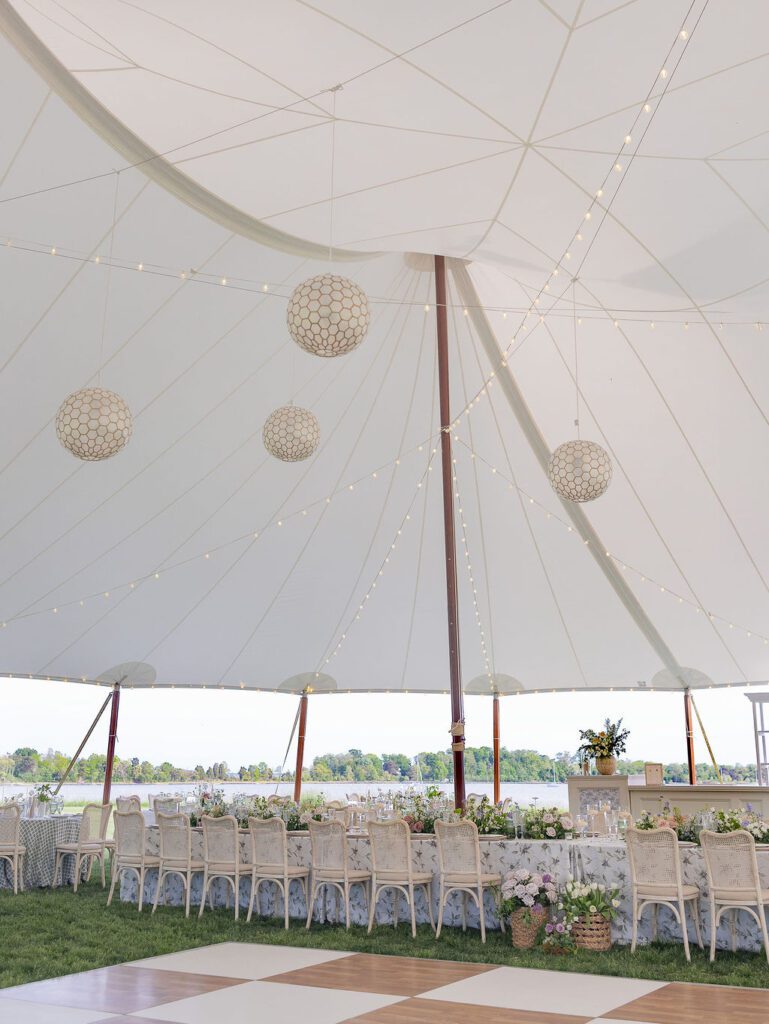 Annapolis waterfront wedding at Whitehall, white and wood checkerboard dance floor and capiz shell chandeliers under a sailcloth tent