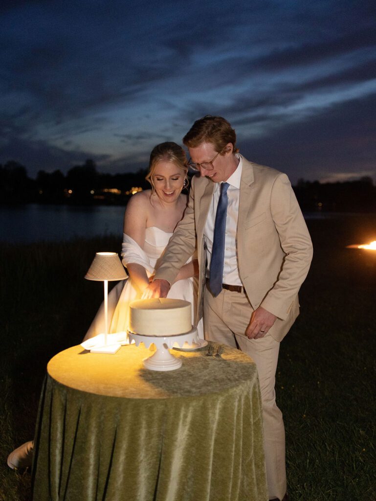 outdoor cake cutting after sunset, smith island cake wedding cake